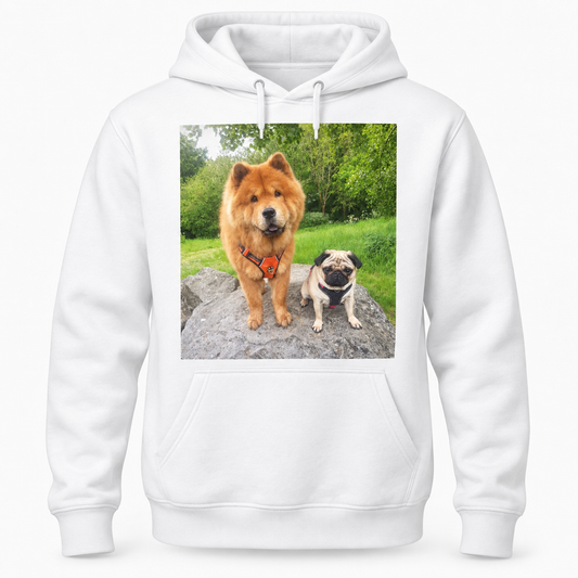 A white long-sleeve hoodie with a square graphic print on the chest showing a fluffy orange dog and a pug sitting on a rock in a green outdoor setting.