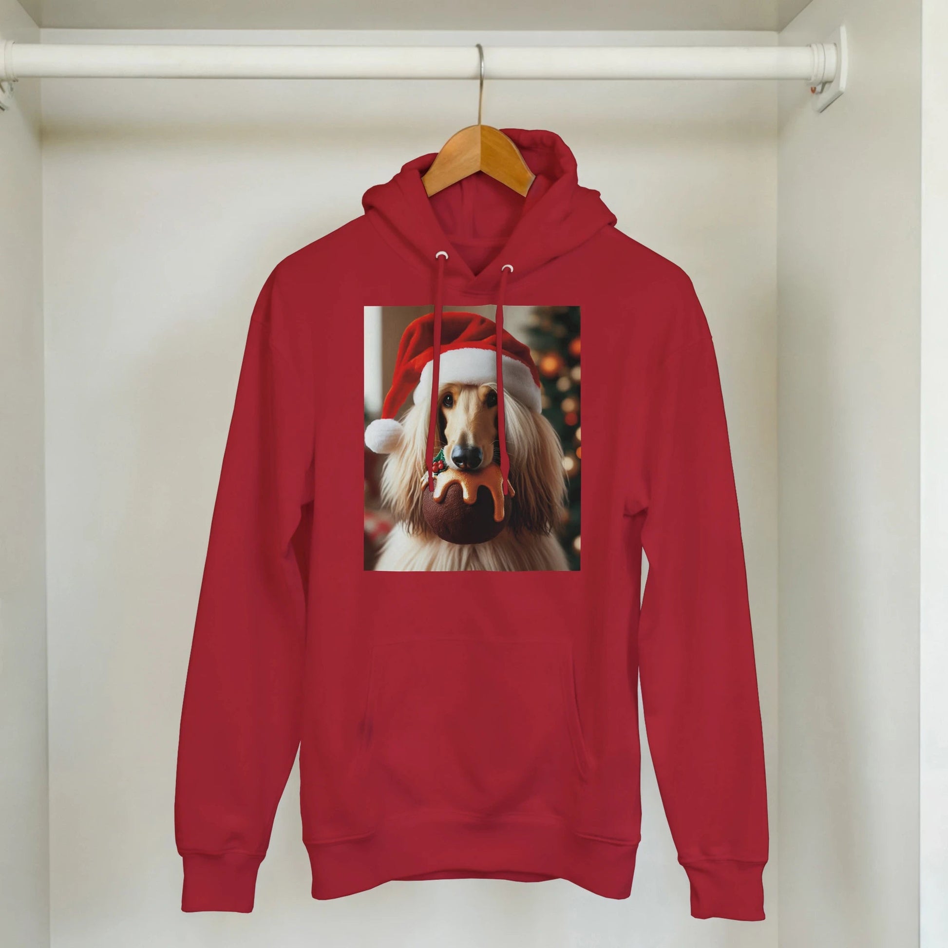 Red hoodie with a dog wearing a Santa hat on a hanger.